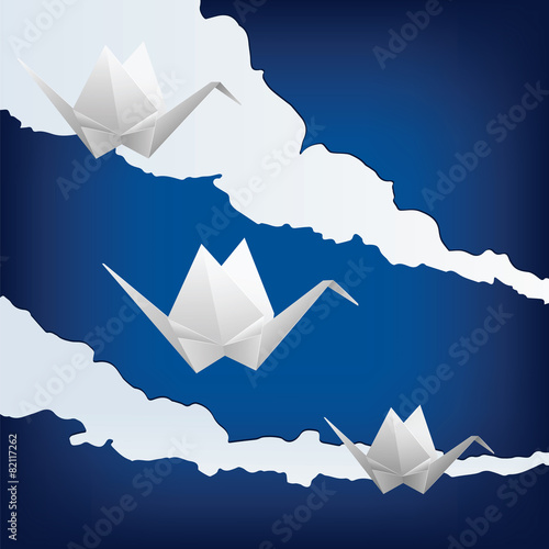 Three paper cranes flying in the sky