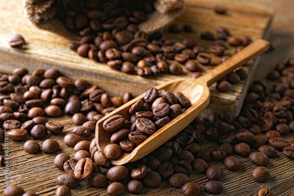 Coffee beans on wooden table, closeup Coffee beans on wooden table, closeup