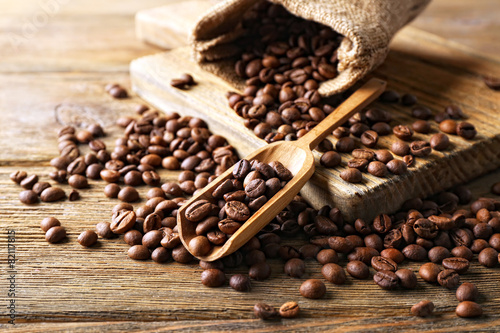 Coffee beans on wooden table, closeup