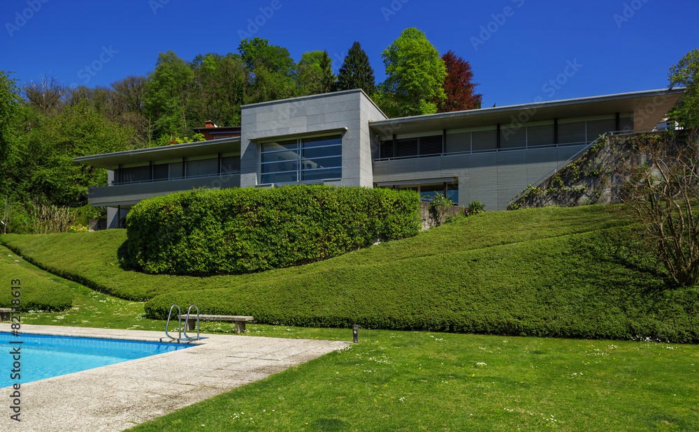 Outside of modern house in summer, swimming pool
