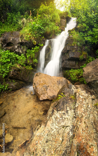 Waterfall in summer canyon. Natural landscape