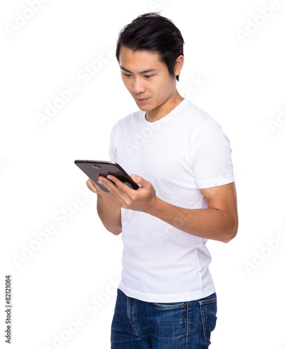 Young asian man use of digital tablet