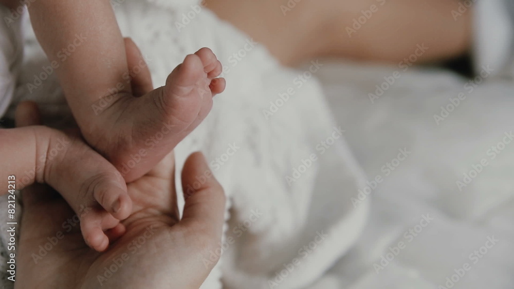 mother hold feets of newborn baby mother hold feets of newborn baby