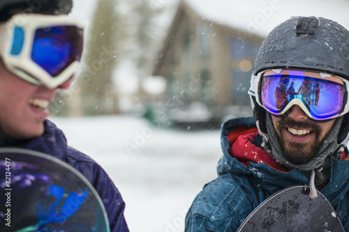 Snowboarders talking in snow photo