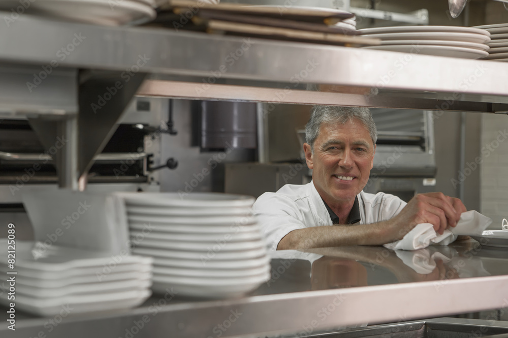 Caucasian chef standing in commercial kitchen Caucasian chef standing in commercial kitchen