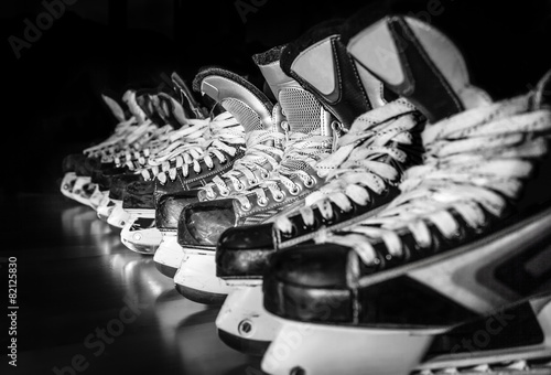 Hockey skates lined up in locker room photo