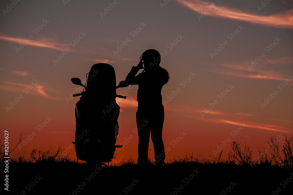 Silhouette motorbike and biker women