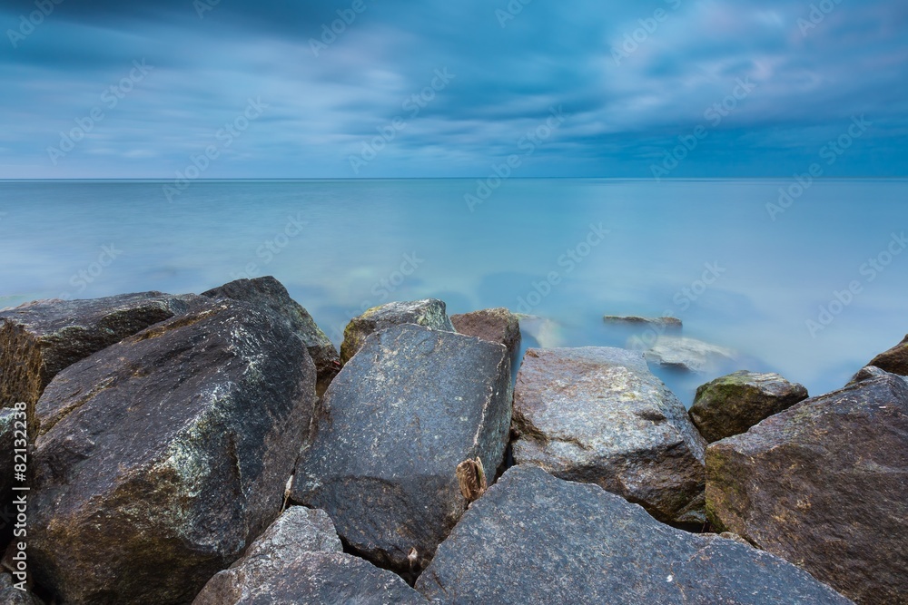 Beautiful Baltic sea landscape with stone breakwater.