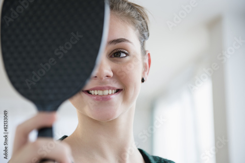 Hispanic girl admiring herself in mirror
