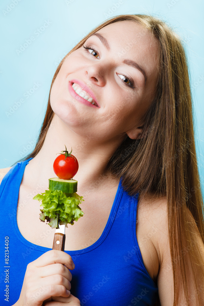 Vegetarian girl holding stack of vegetables. Vegetarian girl holding stack of vegetables.