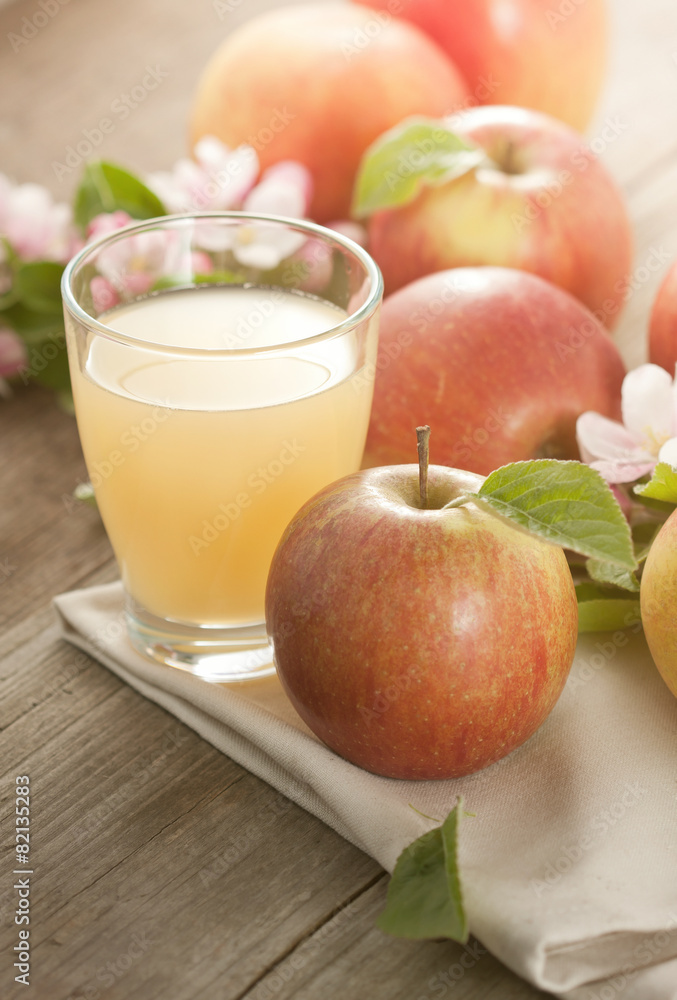 Apple Juice and apples on table in summerlight Apple Juice and apples on table in summerlight