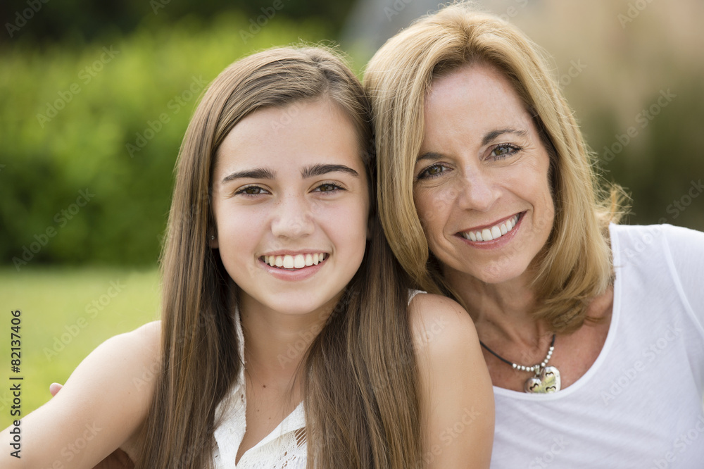 Caucasian mother and daughter smiling outdoors Caucasian mother and daughter smiling outdoors