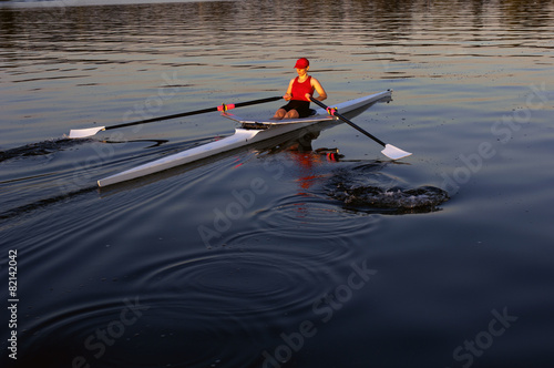Person rowing sculling boat on river