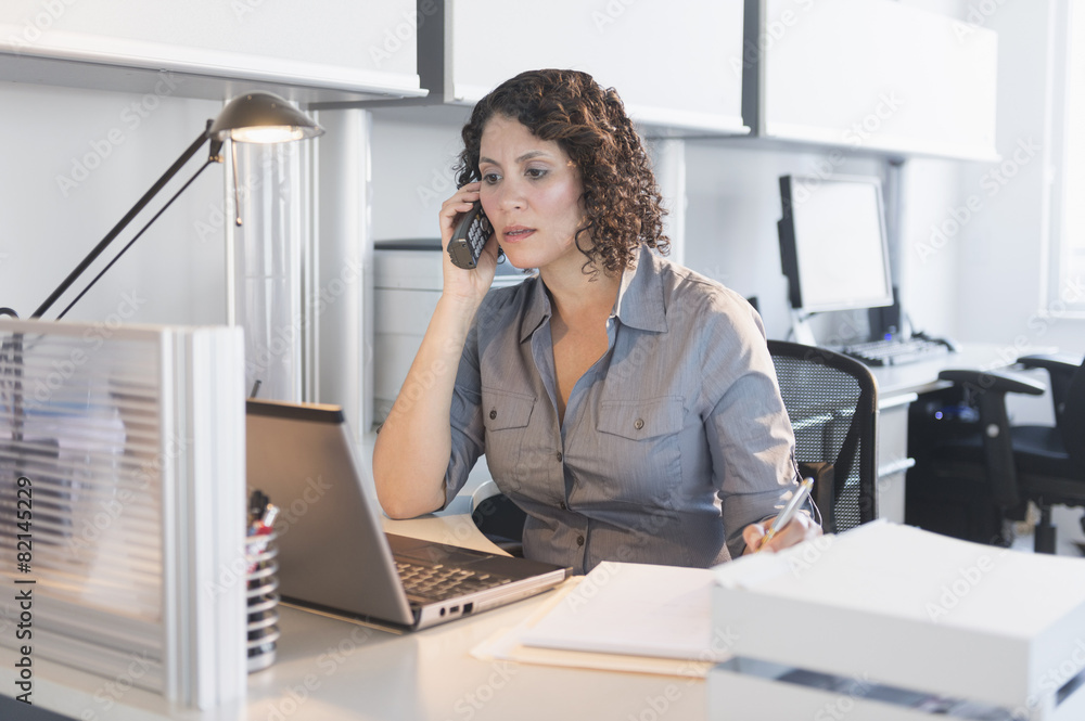 Hispanic businesswoman working in office Hispanic businesswoman working in office