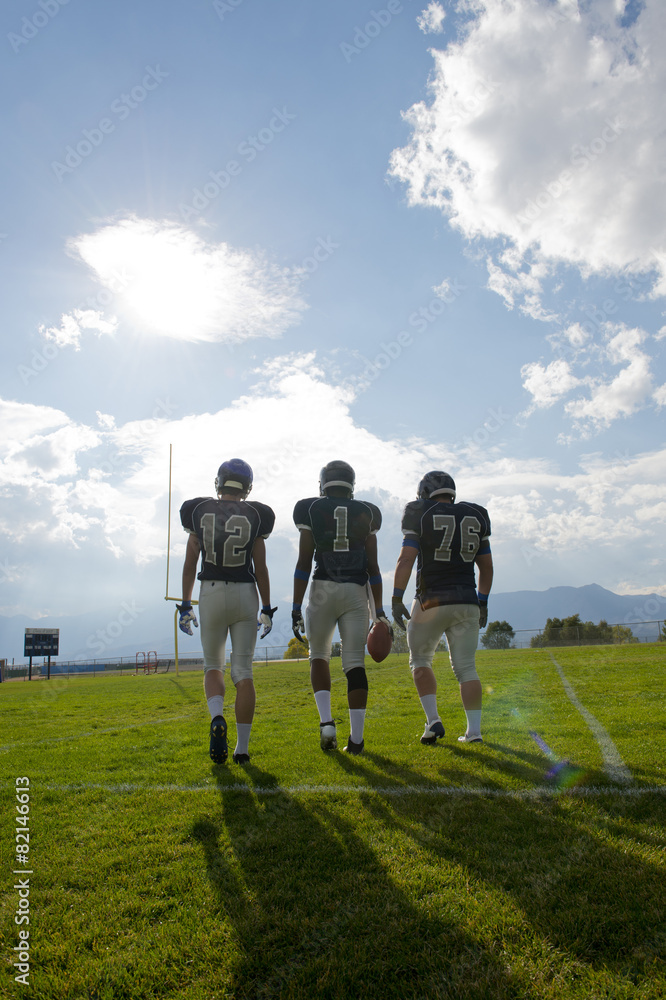 Football players walking on field Football players walking on field