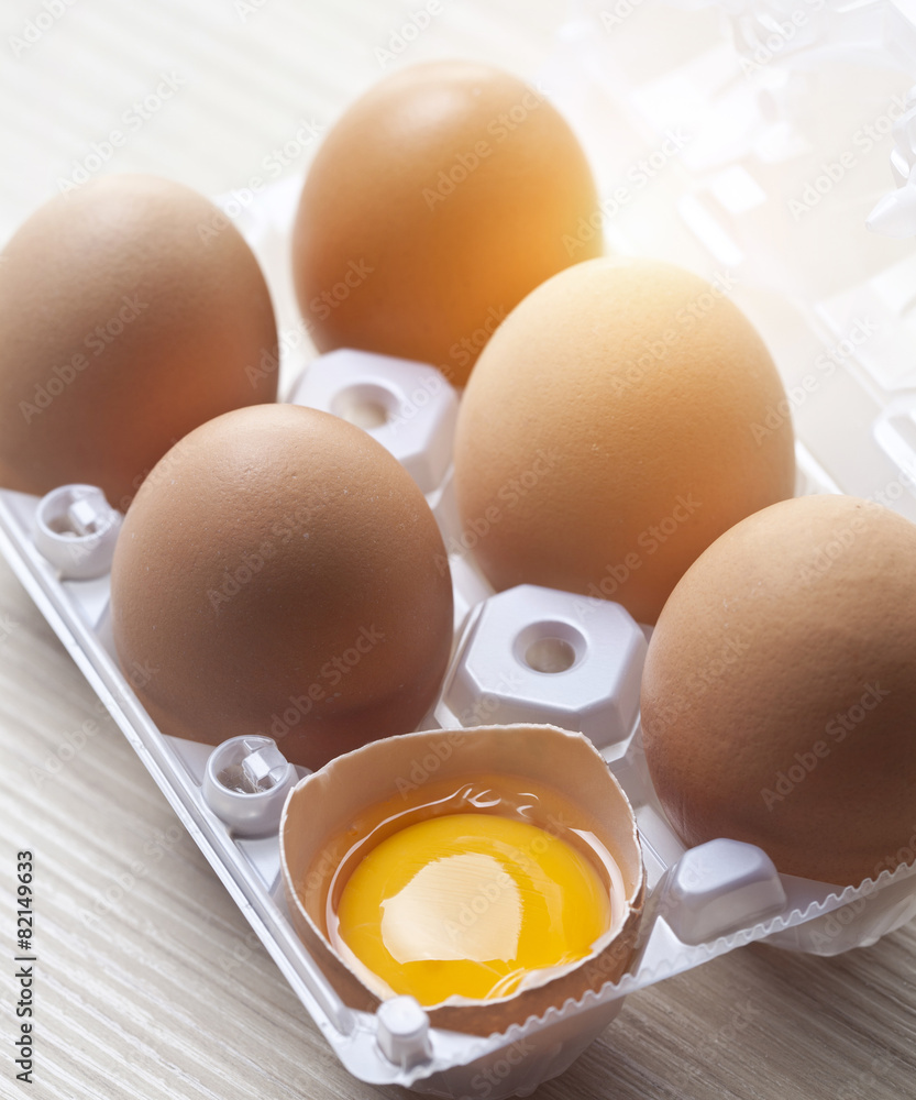 Close up of cracked egg in egg carton Close up of cracked egg in egg carton