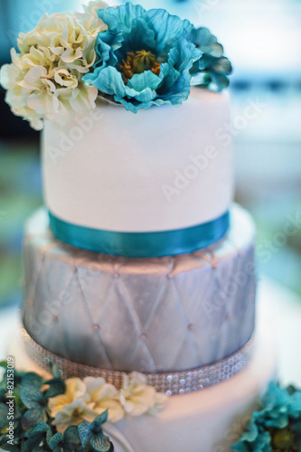 Blue and silver wedding cake with flowers