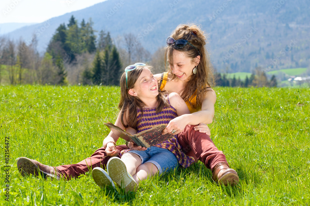 Mom and daughter reading a book Mom and daughter reading a book
