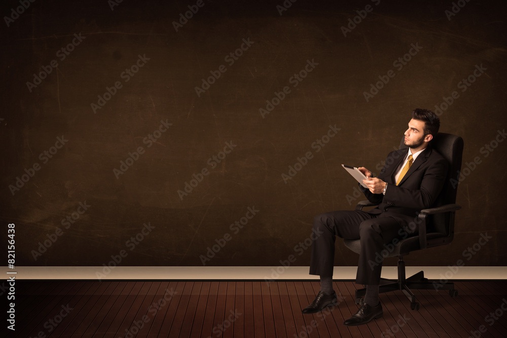 Businessman holding high tech tablet on background with copyspac Businessman holding high tech tablet on background with copyspac