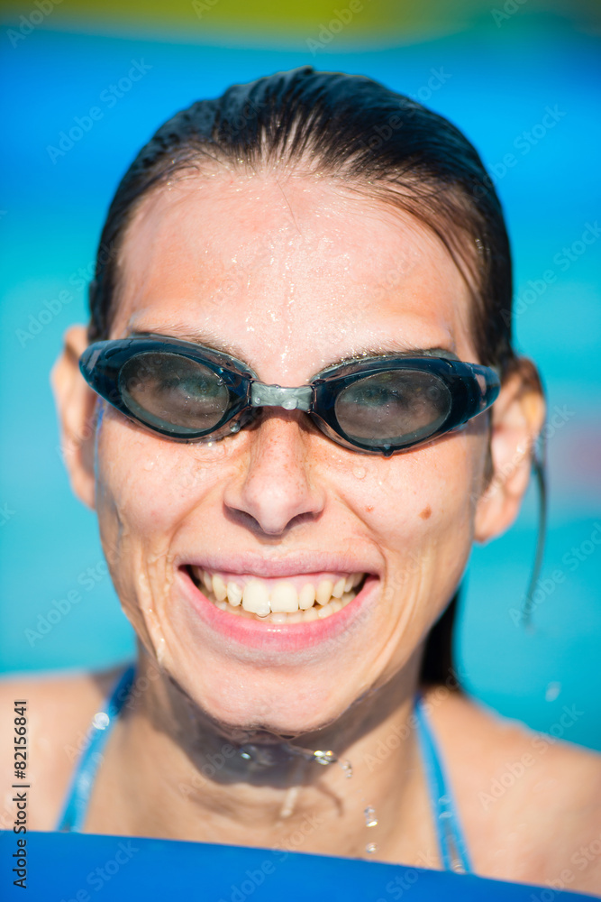Young woman in goggles at swimming pool Young woman in goggles at swimming pool