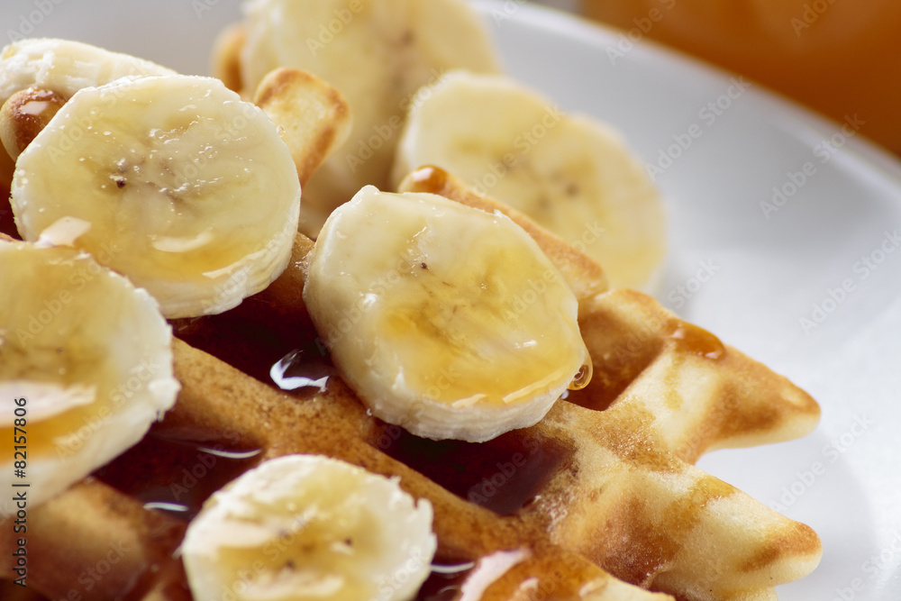 Waffles with bananas covered with maple syrup Waffles with bananas covered with maple syrup