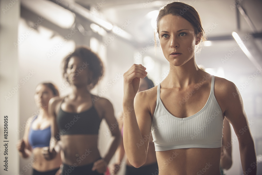 Women working out in exercise class Women working out in exercise class