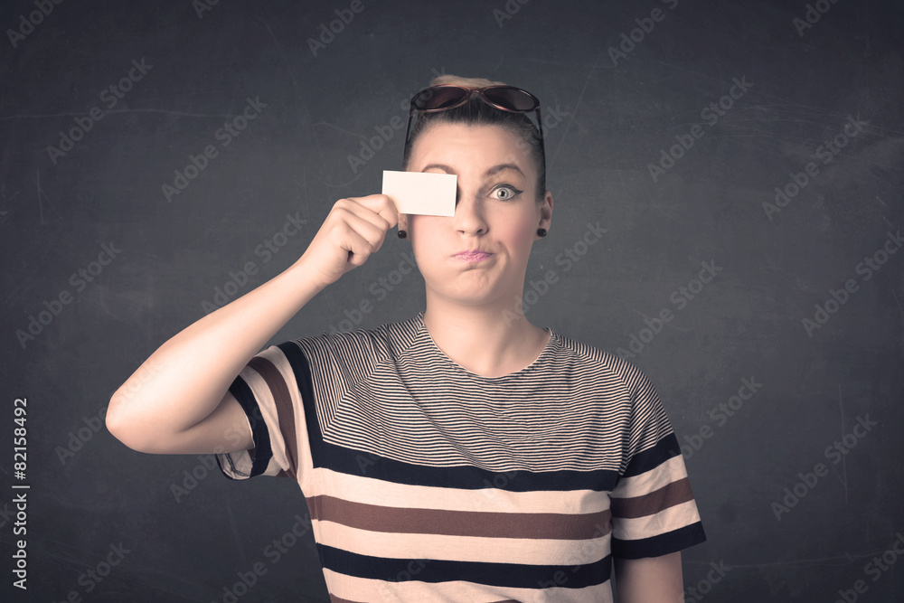 Pretty girl holding blank copy space paper at her eyes Pretty girl holding blank copy space paper at her eyes