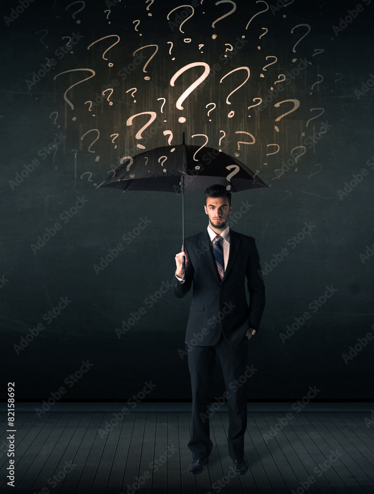 Businessman with umbrella and a lot of drawn question marks Businessman with umbrella and a lot of drawn question marks