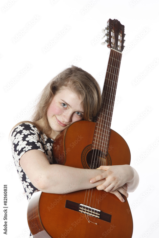 smiling teenage girl in dress holds guitar in studio smiling teenage girl in dress holds guitar in studio