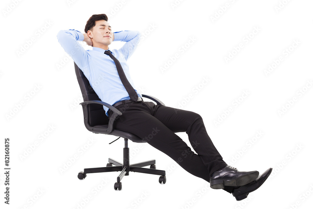 relaxed Young businessman sitting in a chair isolated relaxed Young businessman sitting in a chair isolated