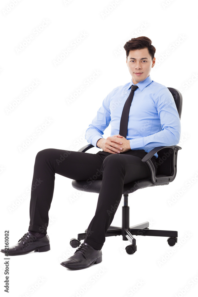 Young businessman sitting in a chair isolated Young businessman sitting in a chair isolated