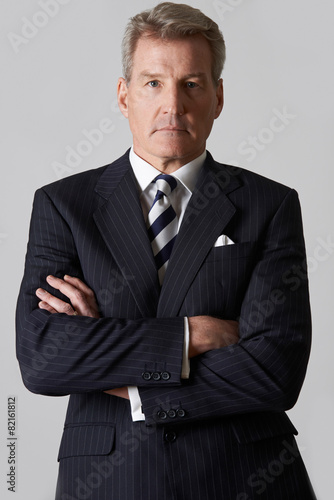 Portrait Of Mature Businessman With Crossed Arms