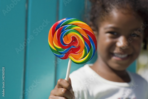 African girl holding lollipop photo