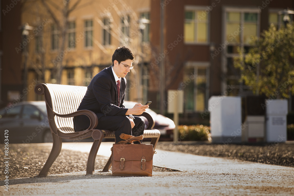 Hispanic businessman using cell phone Hispanic businessman using cell phone