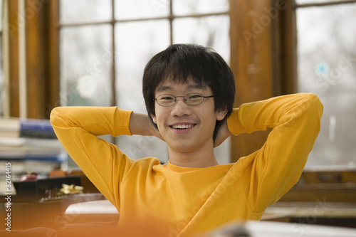 Asian student relaxing in classroom photo