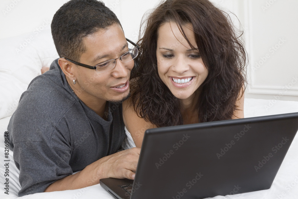 Hispanic couple looking at laptop Hispanic couple looking at laptop