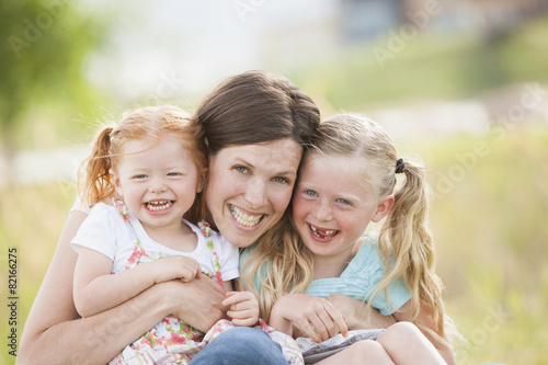 Caucasian mother and daughters smiling outdoors photo