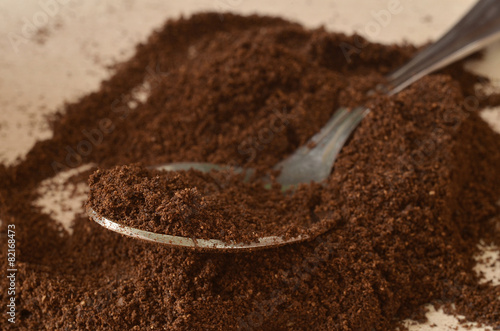 Spoon in light dark powder of coffee