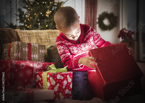 African American boy opening Christmas presents
