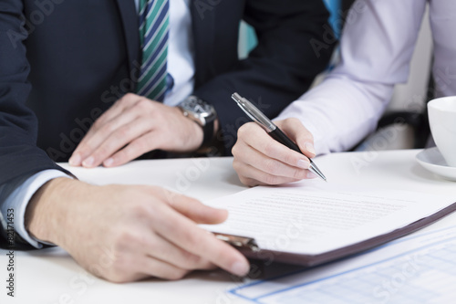 Female hands signing contract