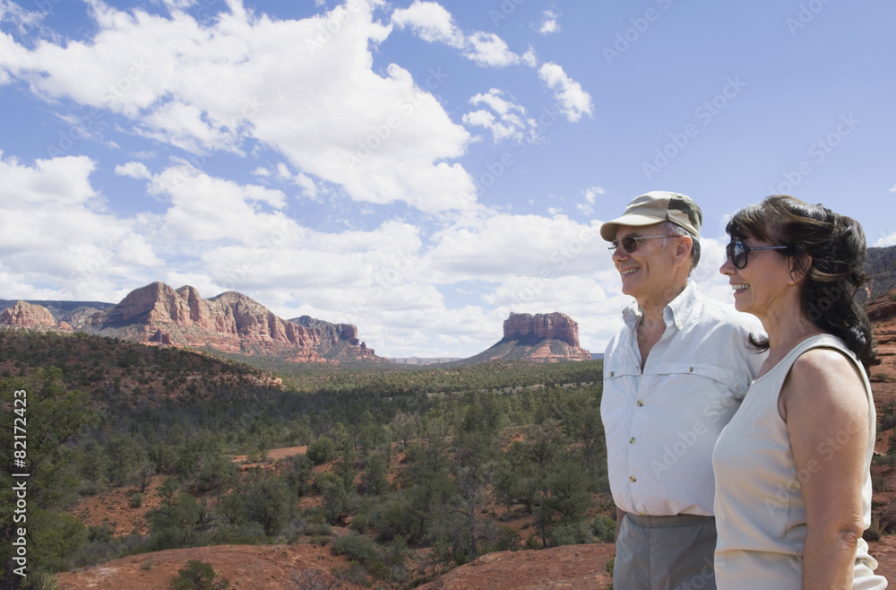 Multi-ethnic senior couple looking at desert landscape Multi-ethnic senior couple looking at desert landscape