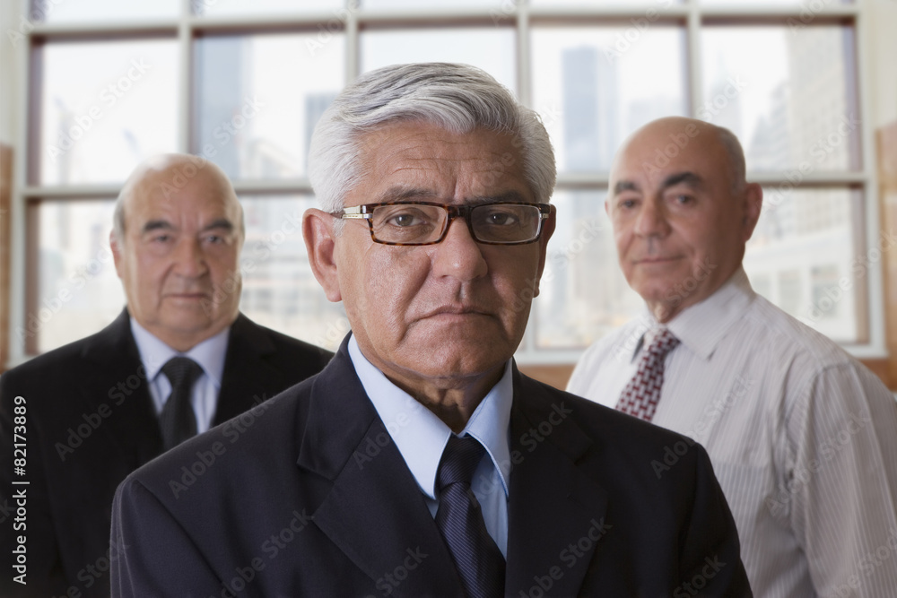 Hispanic businessmen standing in office Hispanic businessmen standing in office