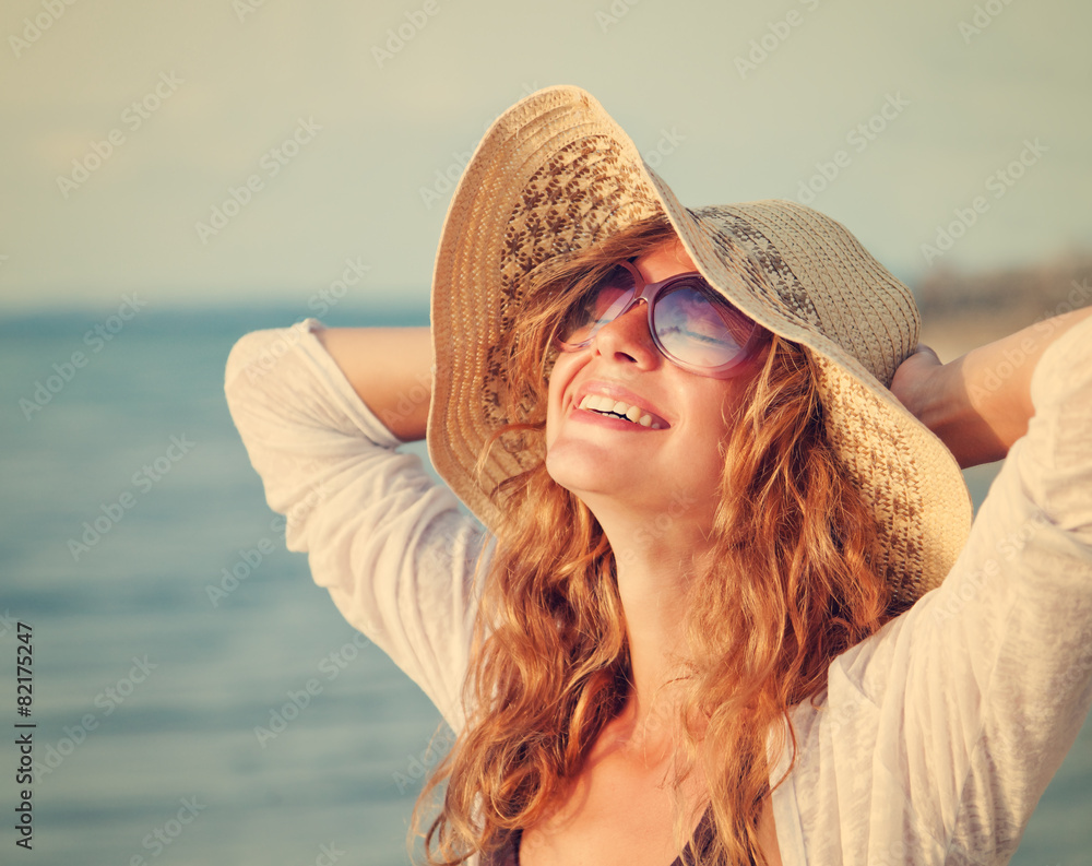 Happy woman relaxing at the beach. Summer vacations concept