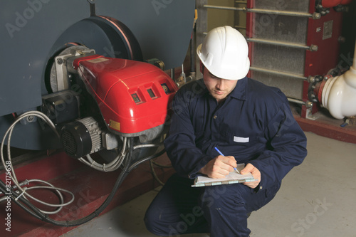 maintenance engineer checking technical data of heating system e