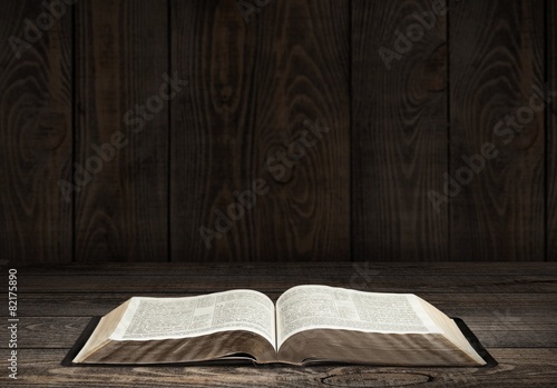 Bible. Image of an old Holy Bible on wooden background in a dark