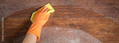 Cleaning soiled parquet in gloves