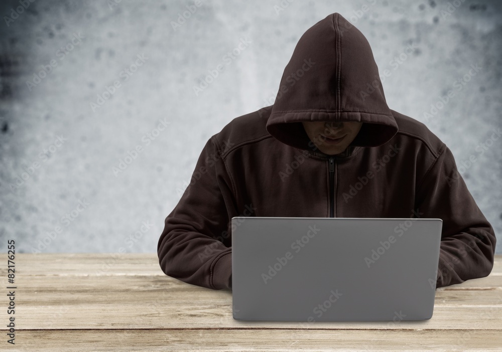 Theft. Hacker typing on a laptop with binary code in background Theft. Hacker typing on a laptop with binary code in background