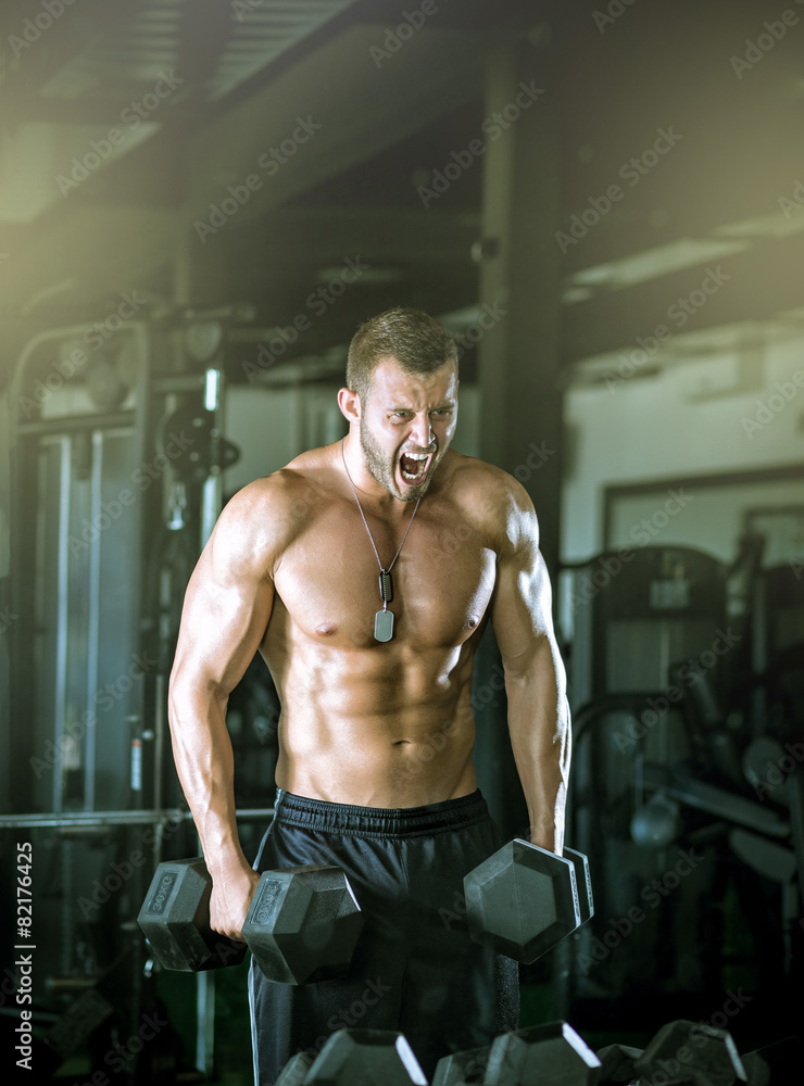 Man doing curls in gym Man doing curls in gym