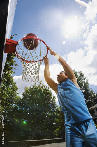 Asian boy playing basketball photo