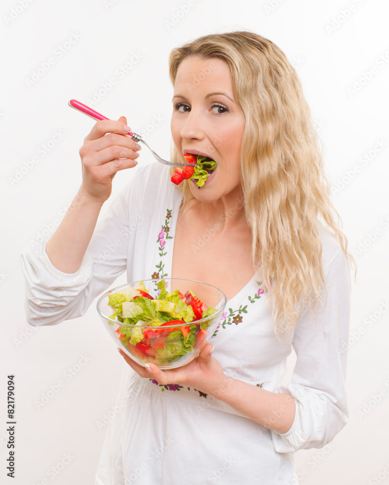 Young housewife eats salad